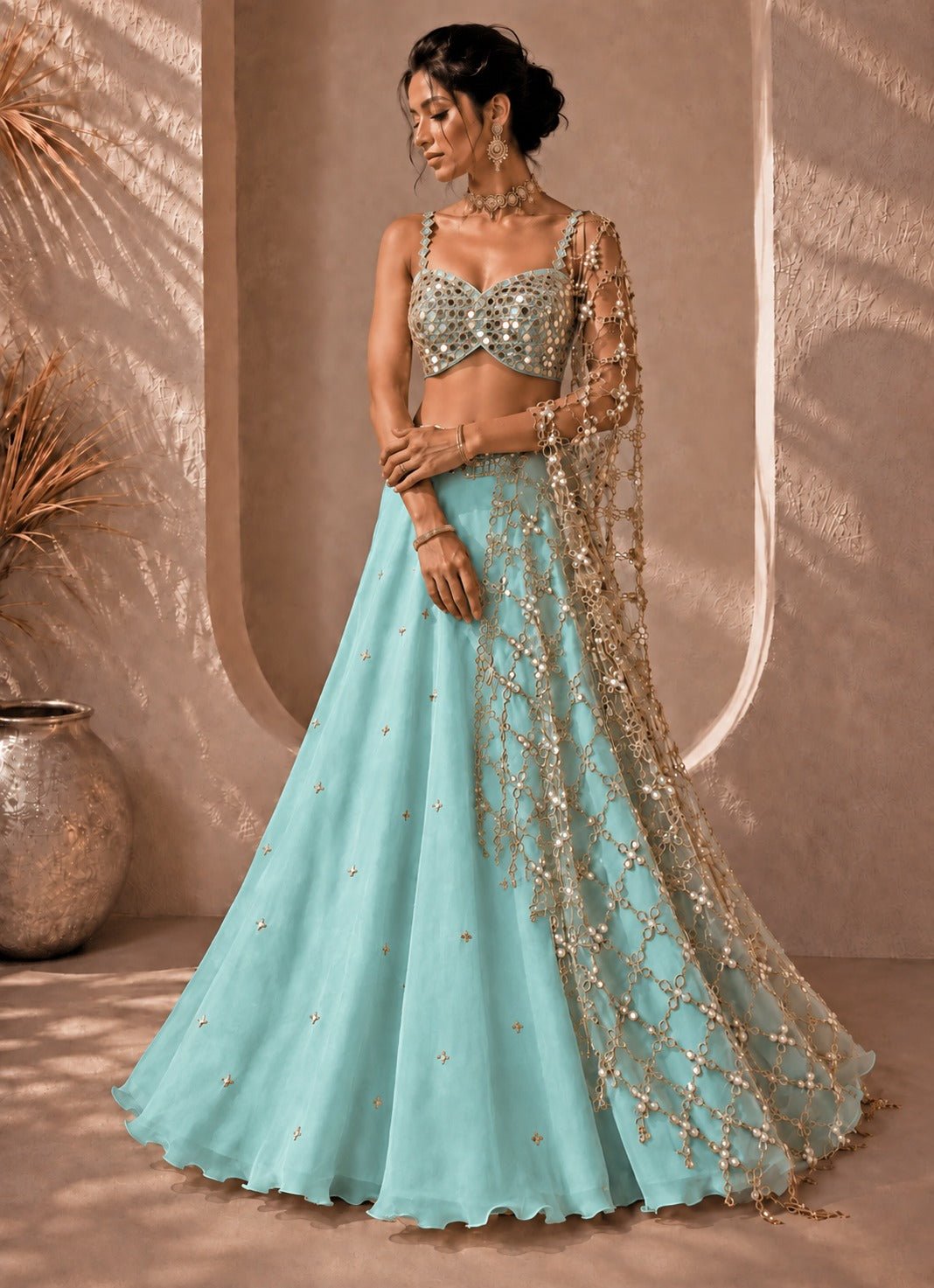 Tiffany blue and muted gold organza lehenga with mirror blouse by Anisha Shetty